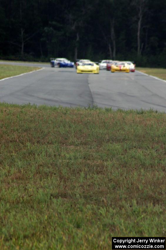 The field comes into turn 4 on the first lap.