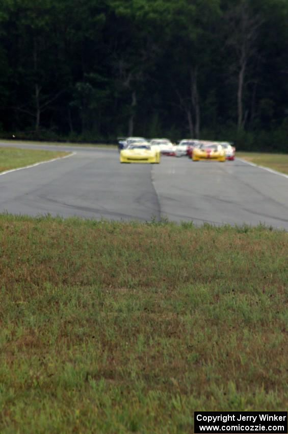 The field comes into turn 4 on the first lap.