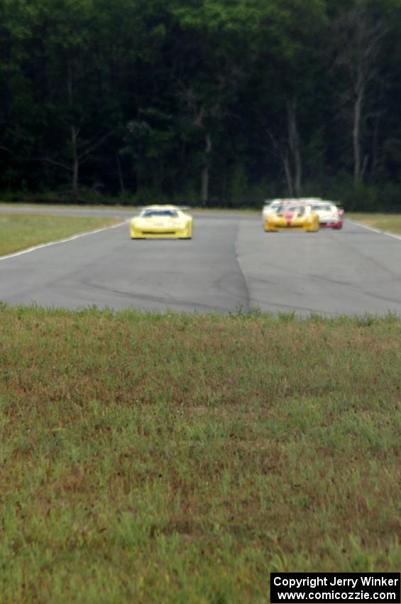 The field comes into turn 4 on the first lap.