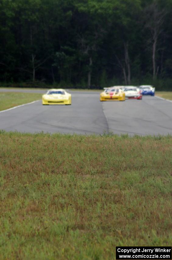 The field comes into turn 4 on the first lap.