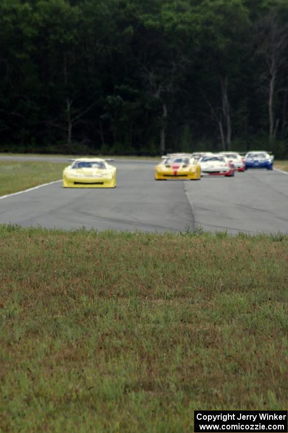 The field comes into turn 4 on the first lap.