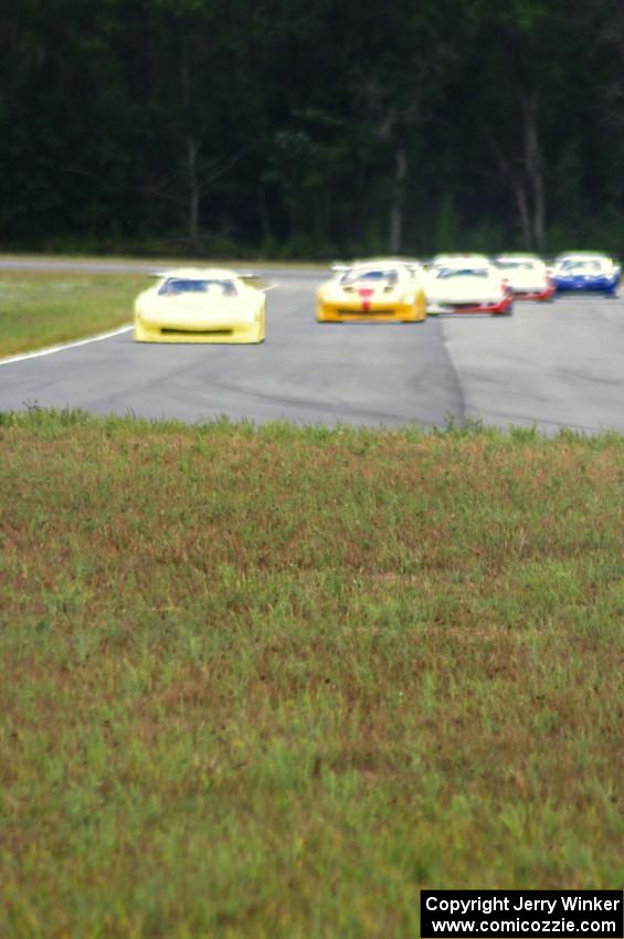 The field comes into turn 4 on the first lap.