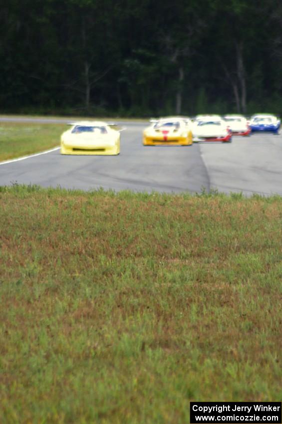 The field comes into turn 4 on the first lap.