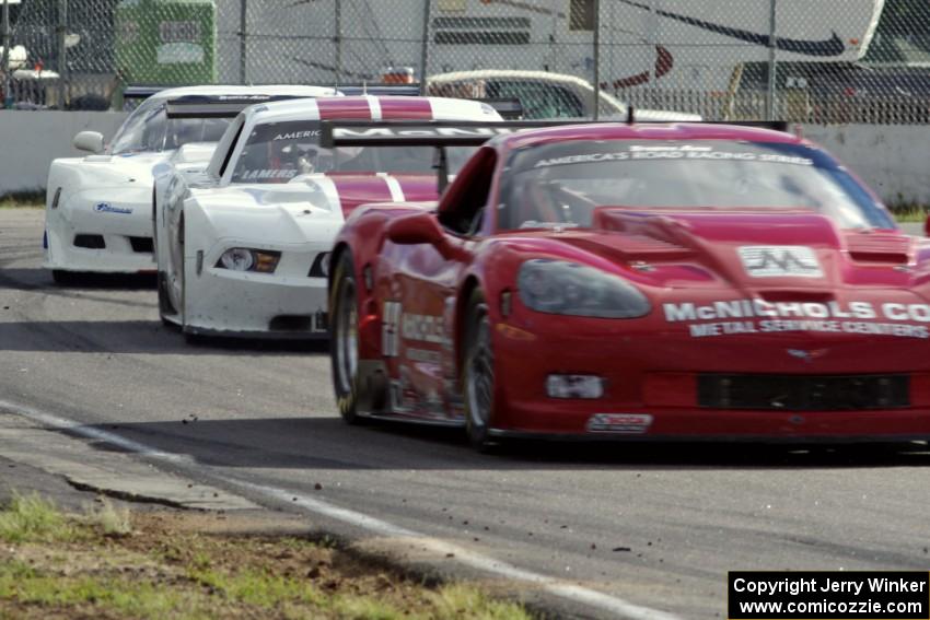 Amy Ruman's Chevy Corvette and Cliff Ebben's Ford Mustang ahead of Simon Gregg's Chevy Corvette