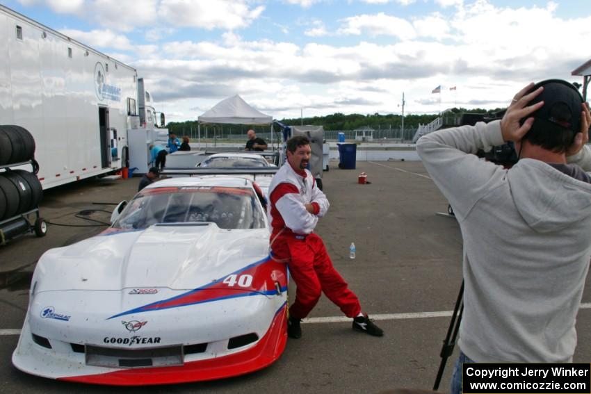 Jed Copham does a post-race interview in front of his Chevy Corvette