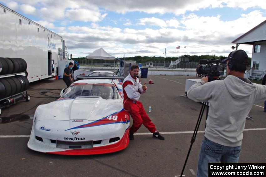 Jed Copham does a post-race interview in front of his Chevy Corvette