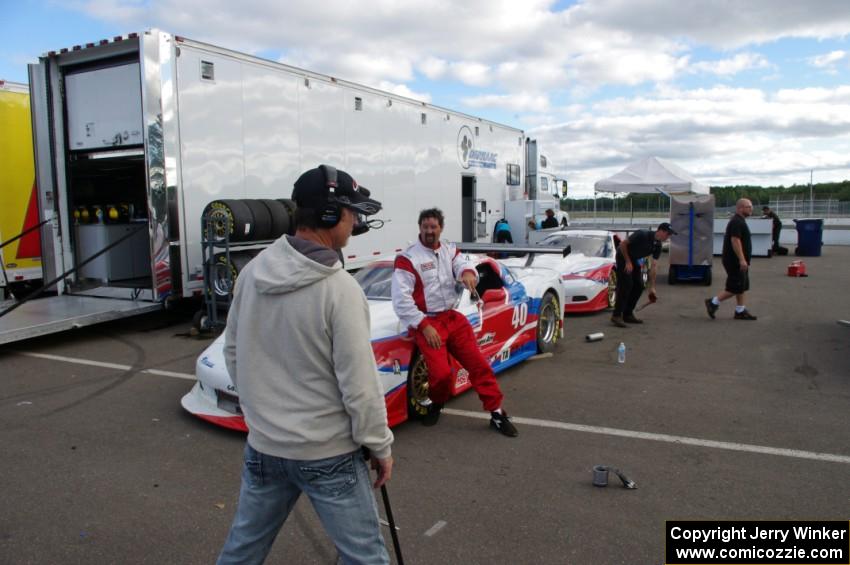 Jed Copham does a post-race interview in front of his Chevy Corvette