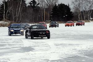 The third portion of the Big Lake Lounge Enduro about to start as cars line up and leave the paddock.