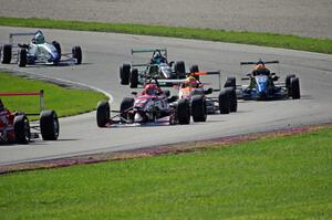 The field streams out of the carousel on lap one.