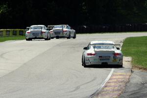 Wayne Ducote (67) chases (30) Angel Benitez, Sr.'s and (02) Wesley Hoaglund's Porsche GT3 Cup cars