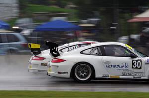 Angel Benitez, Sr.'s Porsche GT3 Cup passes another car going into turn three