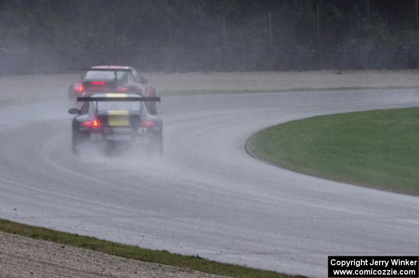 John Baker's and Porsche GT3 Cup cars in the carousel in the pouring rain