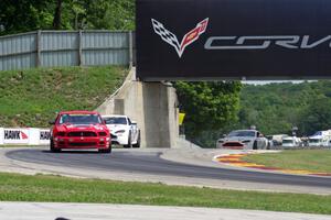 Joey Atterbury / Tim Bell Ford Mustang Boss 302R GT holds off a pair of Aston Martin Vantages