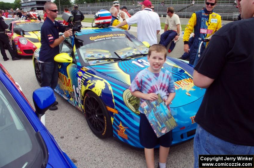 A young fan poses in front of the Nick Longhi / Matt Plumb Porsche 997