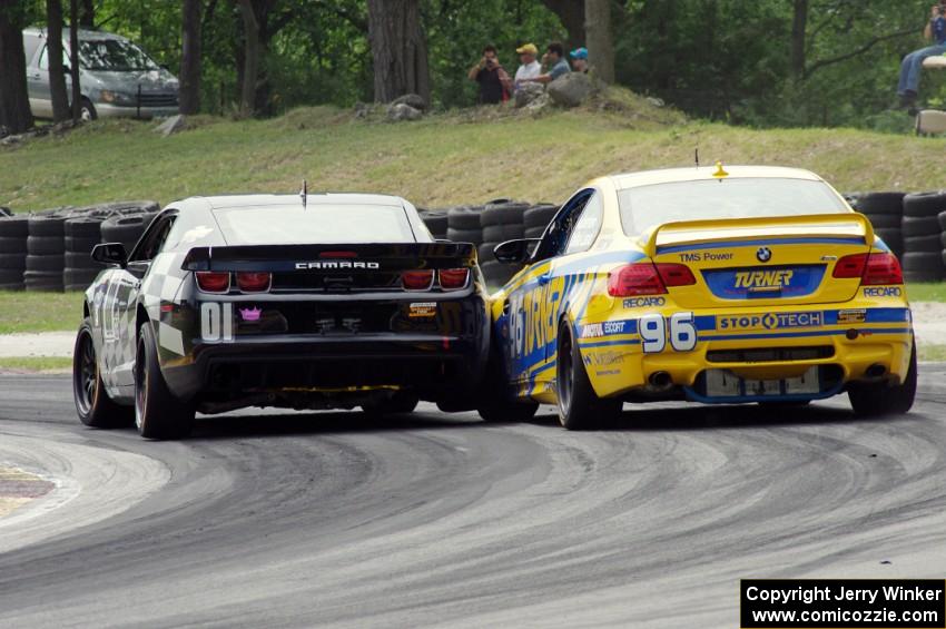 Lawson Aschenbach / Eric Curran Camaro GS.R nudges the Bill Auberlen / Paul Dalla Lana BMW M3 Coupe