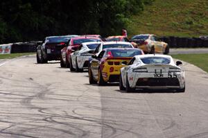 Jade Buford / Scott Maxwell Aston Martin Vantage trails a group of GS cars into turn 7