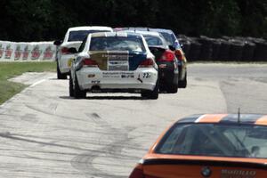 Terry Borcheller / Mike LaMarra BMW 128i trails a group of ST cars into turn 7