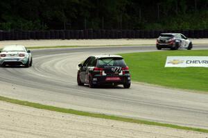 Ian Baas / Kevin Gleason VW GTI chases Taylor Hacquard / Kenton Koch Mazda Speed 3 and Andrew Carbonell/Rhett O'Doski Mazda MX-5