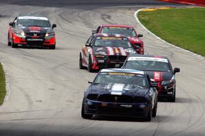 Ian James / Roger Miller Ford Mustang Boss 302R GT leads a pack of cars into the carousel
