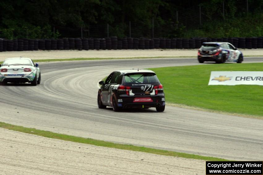 Ian Baas / Kevin Gleason VW GTI chases Taylor Hacquard / Kenton Koch Mazda Speed 3 and Andrew Carbonell/Rhett O'Doski Mazda MX-5