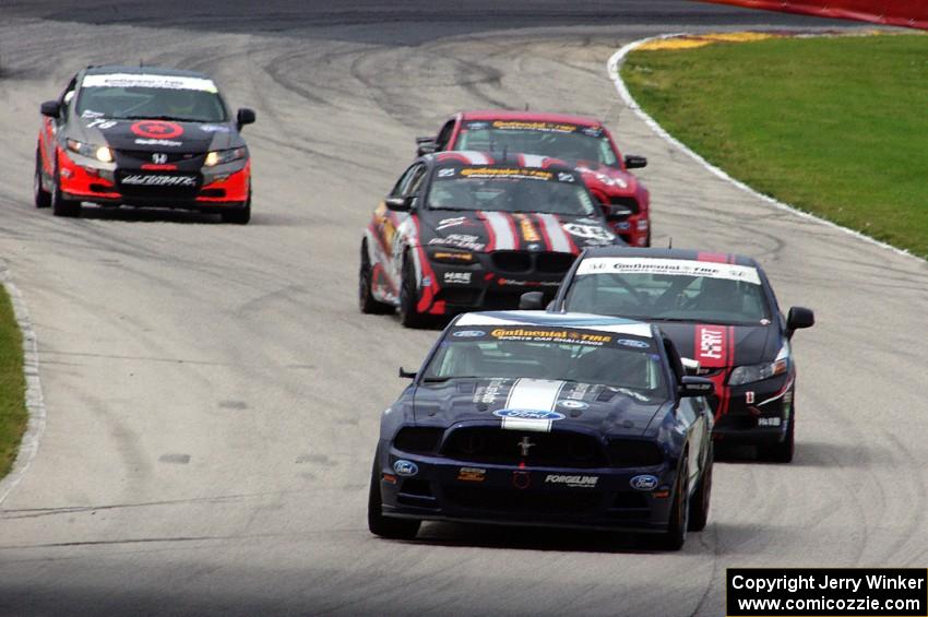 Ian James / Roger Miller Ford Mustang Boss 302R GT leads a pack of cars into the carousel