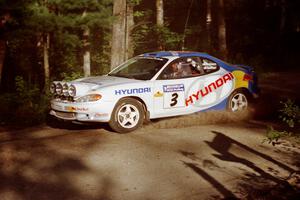 Paul Choiniere / Jeff Becker Hyundai Tiburon at a 90-right on SS1, Akeley Cutoff.