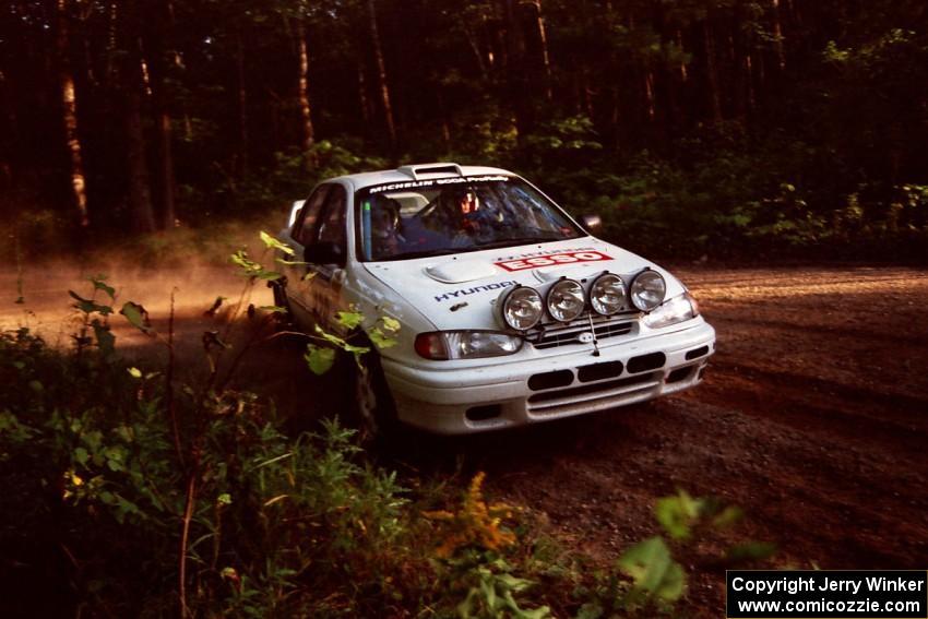 Dean Panton / Michael Fennell Hyundai Elantra at a 90-right on SS1, Akeley Cutoff.