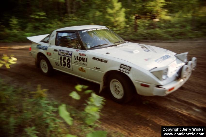 Ted Grzelak / Chris Plante Mazda RX-7 at a 90-right on SS1, Akeley Cutoff.