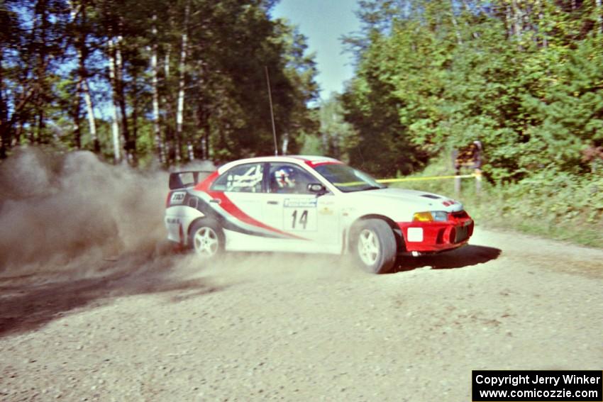 Garen Shrader / Doc Schrader Mitsubishi Lancer Evo IV powers out of a corner on SS11, Anchor Hill.