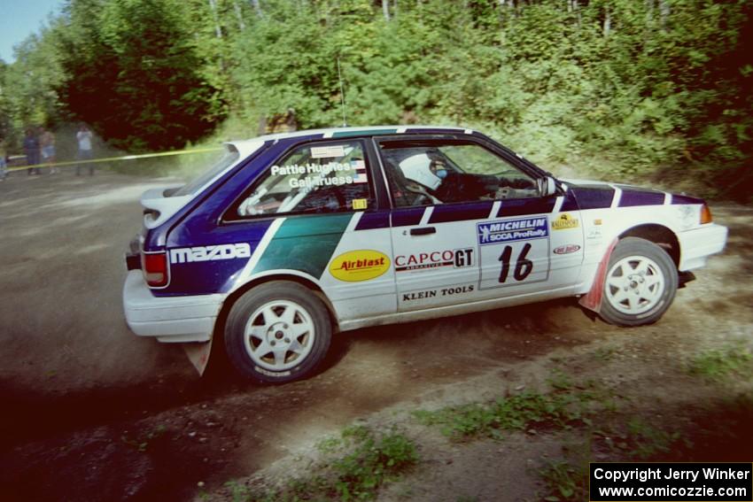 Gail Truess / Pattie Hughes Mazda 323GTX powers out of a corner on SS11, Anchor Hill.