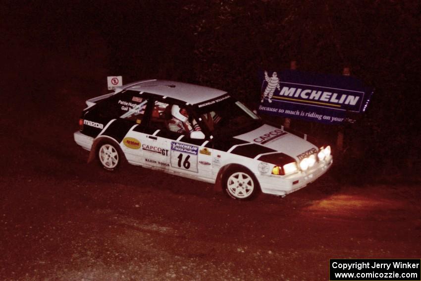 Gail Truess / Pattie Hughes Mazda 323GTX comes through the spectator corner on SS14, Perkins Road.