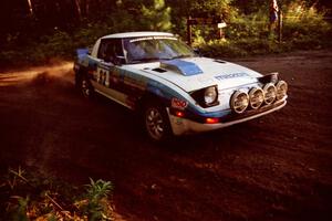 Mike Hurst / Rob Bohn Mazda RX-7 at a 90-right on SS1, Akeley Cutoff.