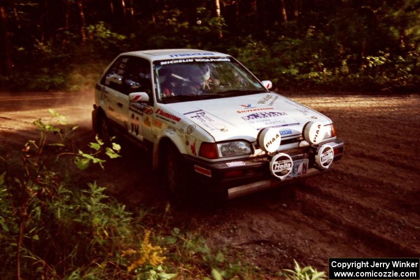 Lauchlin O'Sullivan / John Dillon Mazda 323GTX at a 90-right on SS1, Akeley Cutoff.