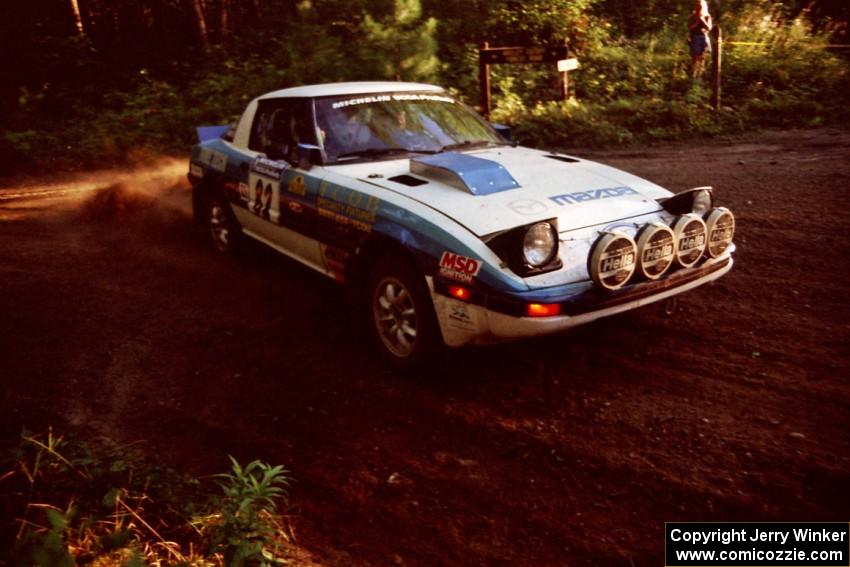 Mike Hurst / Rob Bohn Mazda RX-7 at a 90-right on SS1, Akeley Cutoff.