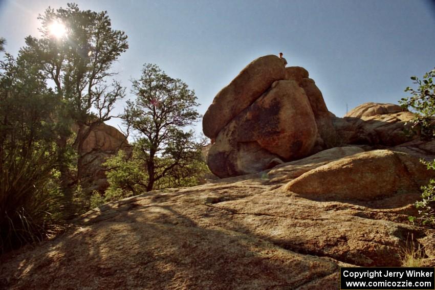 James Bialas hikes to the top of a large rock at the Granite Dells outside of Prescott, AZ