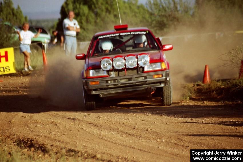 Doug Robinson / Sue Robinson Mazda 323GTX at the spectator corner on SS8, Limestone I.