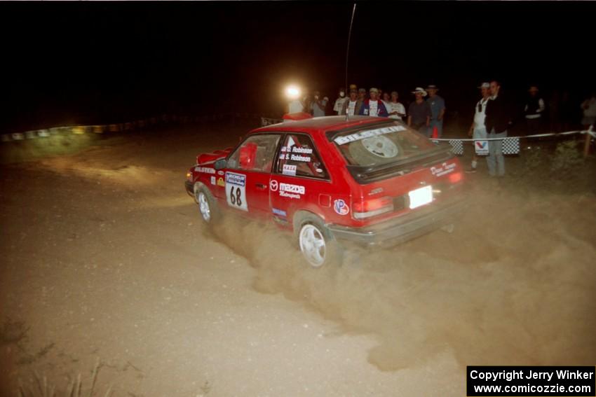 Doug Robinson / Sue Robinson Mazda 323GTX at the spectator corner on SS9, Limestone II.