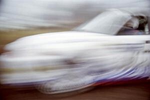 Karl Scheible / Gail McGuire Mitsubishi Lancer Evo V at speed on the practice stage.