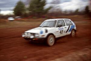 Eric Burmeister / Mark Buskirk VW GTI at speed on the practice stage.