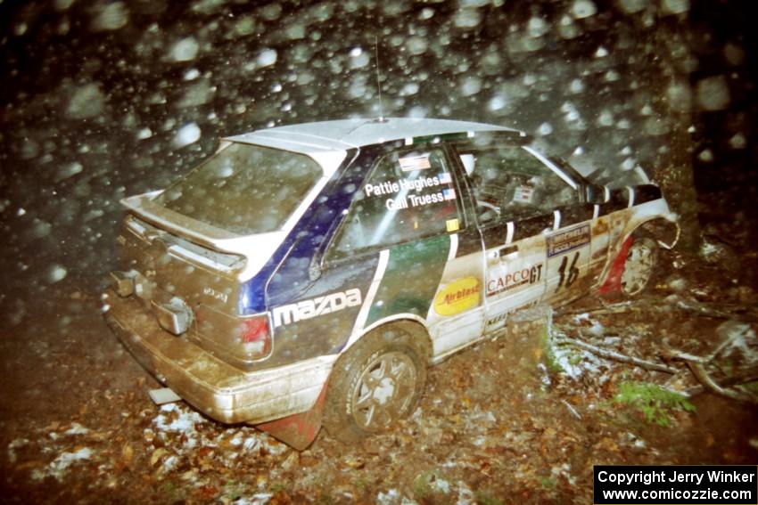 Gail Truess / Pattie Hughes Mazda 323GTX crashed heavily into a tree at the flying finish of SS5, Passmore.