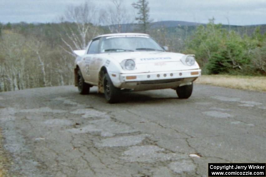 Ted Grzelak / Chris Plante Mazda RX-7 at the final yump on SS14, Brockway Mountain I.