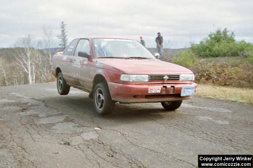 Eric Seppanen / Emily Burton-Weinman Nissan Sentra SE-R at the final yump on SS14, Brockway Mountain I.