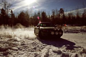 Tad Ohtake / Cindy Krolikowski drift past spectators on SS1, Hungry 5, in their Ford Escort ZX2.