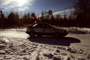 Mark Cox / Jim Gill drift past spectators on SS1, Hungry 5, in their Mazda 323GTX.