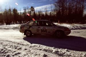 The Charlie Langan / Hughie Langan Ford Escort GT drives past spectators on SS1, Hungry 5.