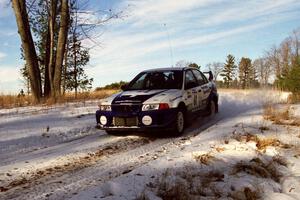 The Karl Scheible / Russ Hughes Mitsubishi Lancer Evo V comes over a small crest on SS7, Ranch II.