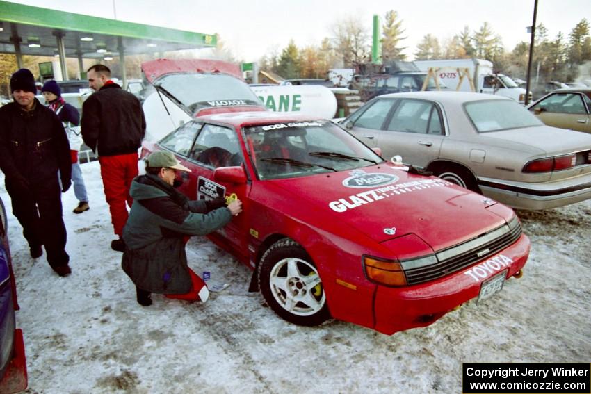 The Paul Dunn / Brian Jenkins Toyota Celica All-Trac gets stickers added to it in the parking lot before parc expose.