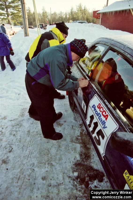 Last minute stickers are added to the Seamus Burke / Frank Cunningham Subaru WRX at parc expose.