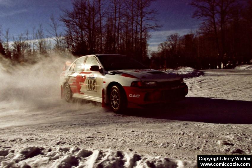 Bill Morton / Rob Walden drift past spectators on SS1, Hungry 5, in their Mitsubishi Lancer Evo IV.