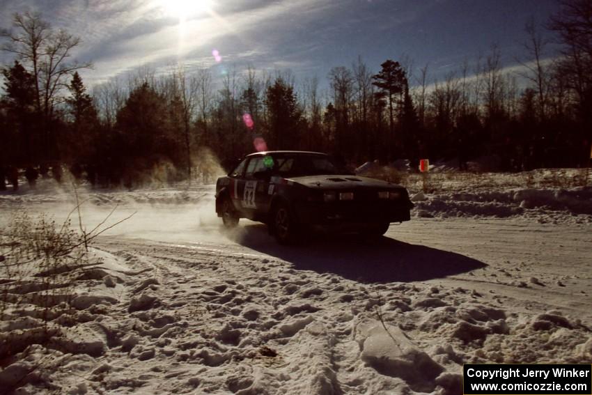 Mike Hurst / Rob Bohn drift their Pontiac Sunbird Turbo past spectators on SS1, Hungry 5.